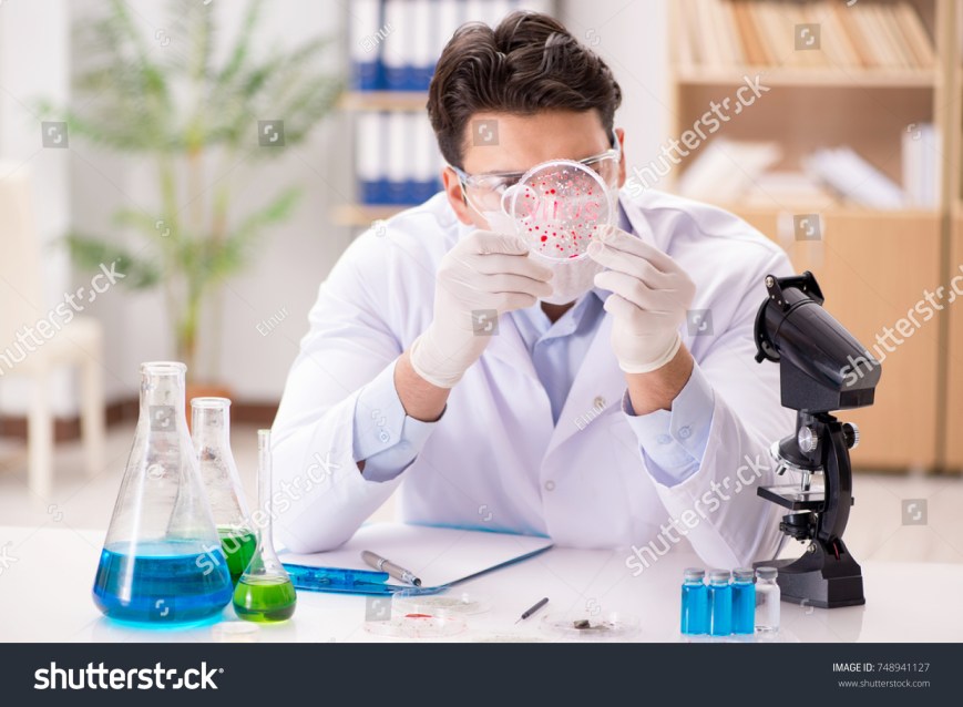 stock-photo-male-doctor-working-in-the-lab-on-virus-vaccine-748941127